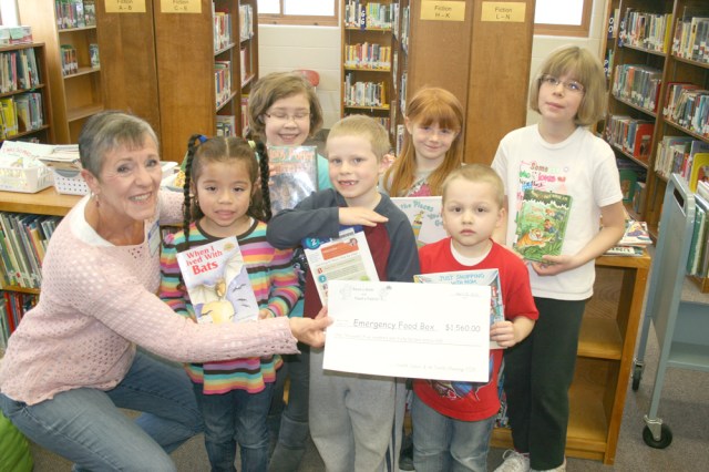 Ada Brown, co-chair of the Emergency Food Box Board, accepts a check from the Franklin PTSA for $1,560.