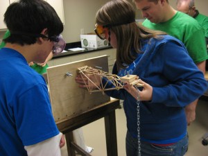 Joey Escobedo and Nicole Lacina mounting their balsa wood boomilever to the testing platform.