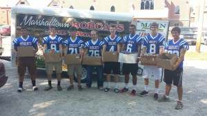 Bobcat Football players drop off donated food items at the Emergency Food Box. 
