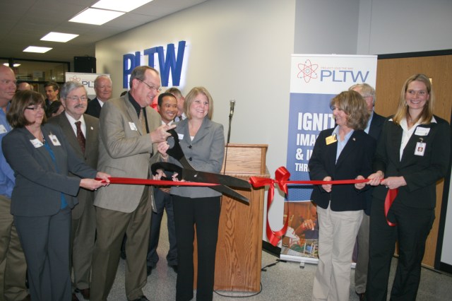 School Board President Sherm Welker and Vice President Jennifer Wilson wield the scissors as the biomedical sciences lab is officially opened at Marshalltown High School. 