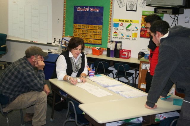 Hoglan teacher Amy Pollard shows parents learning activities they can do at home with their kids.