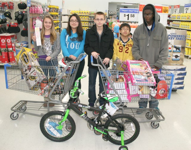 Five Miller Middle School eighth grade students purchased gifts for those in need Thursday at Walmart with money raised by the entire class. Pictured with the toys purchased are, from left, Macey Lolwing, Jazmin Ibarra, David Barlow, Cody Songkhamdet and Demiko Deng.